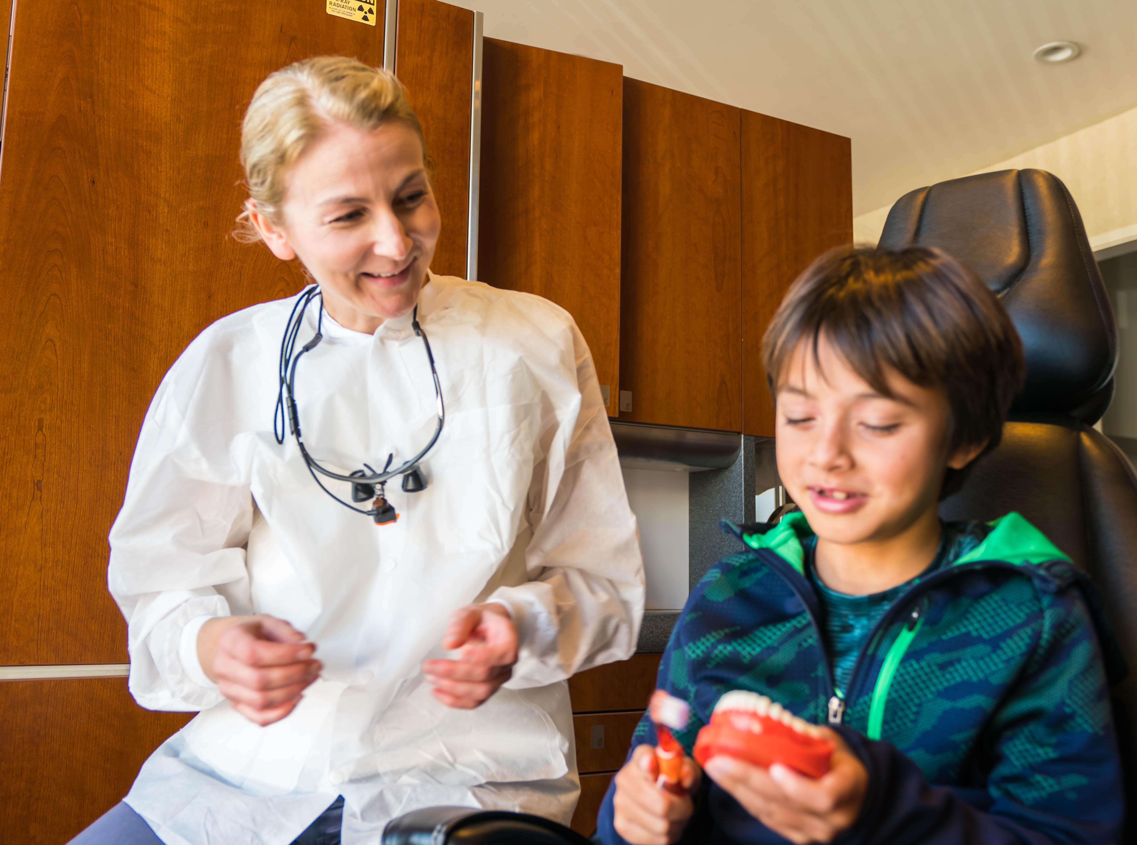 image of Dr. Diana Dizik with a child patient