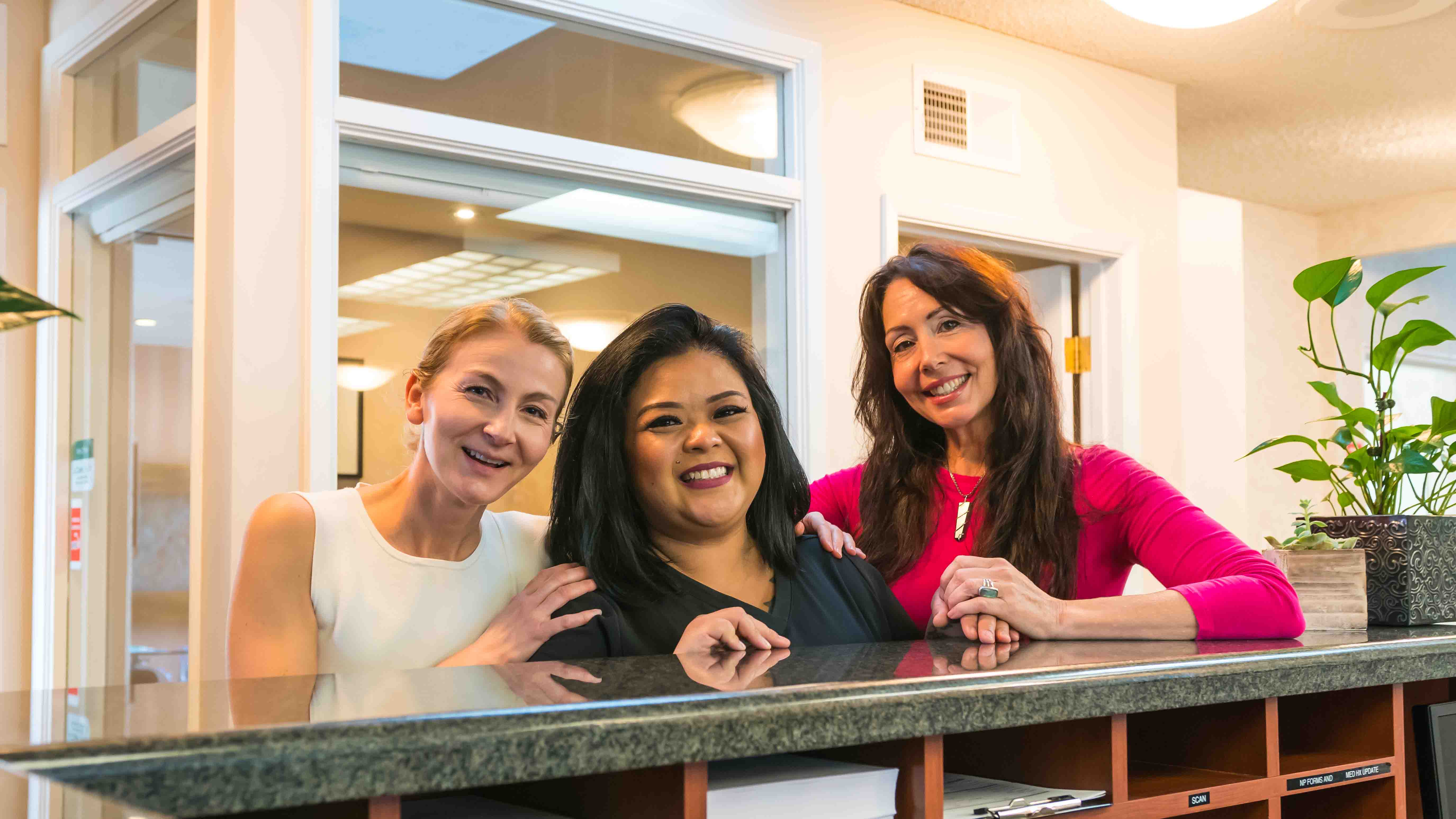 Photo of a female staff member laughing with a male patient.