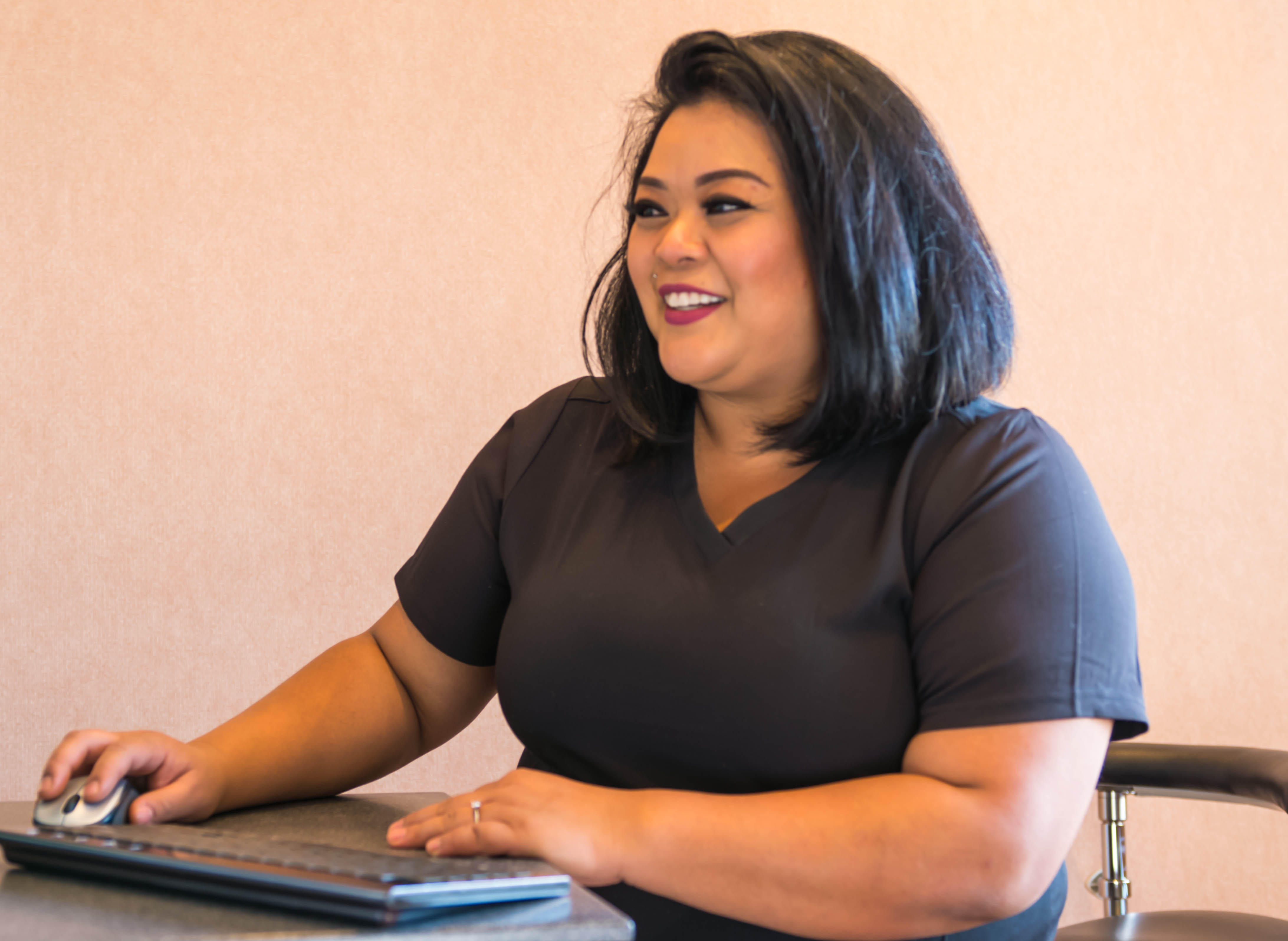 Photo of a female staff member laughing with a male patient.