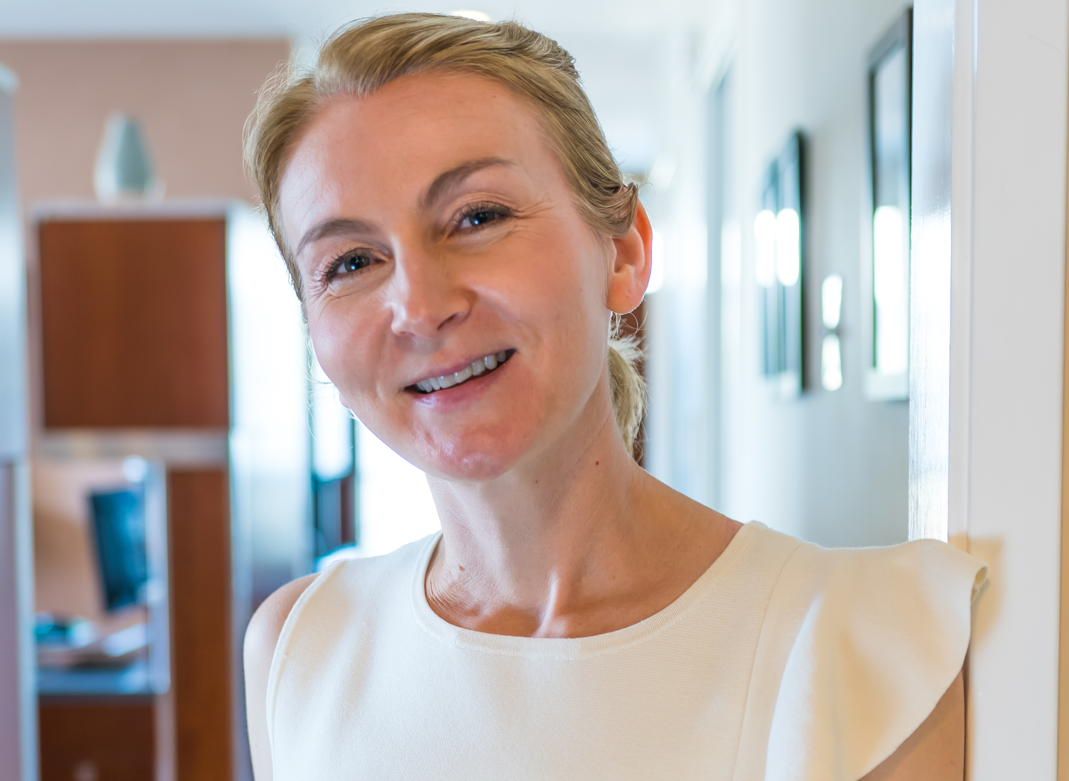 Photo of a female staff member laughing with a male patient.